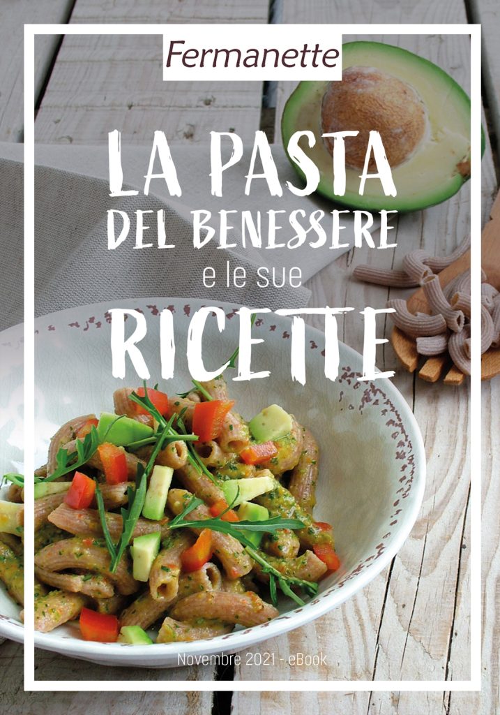 La copertina del libro di ricette creato da Paola Uberti per il brand Fermanette by Tesei. Su un piano di legno si trovano un piatto di pasta integrale e verdure e un avocado.